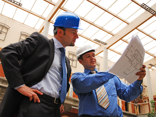 architect and supervisor  Reviewing Blueprints