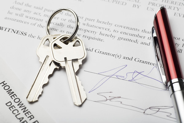 house keys with signed settlement document and pen; signatures are fictitious