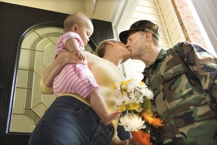 Soldier kissing wife