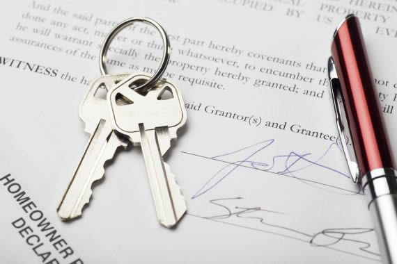 house keys with signed settlement document and pen; signatures are fictitious
